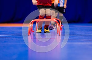 Futsal jumping drills. Futsal indoor soccer training session. Young futsal players exercising for agility and coordination photo