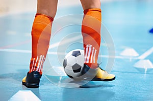 Futsal league. Indoor soccer player in futsal shoes training dribble drill with ball. Indoor soccer training