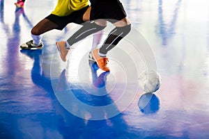 Futsal player trap and control the ball for shoot to goal.