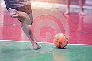 Futsal players barefoot. Futsal player  control and shoot ball to goal