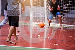 Futsal players barefoot. Futsal player control and shoot ball to goal with goalkeeper