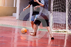 Futsal players barefoot. Futsal player  control and shoot ball to goal. Soccer players fighting each other by kicking the ball