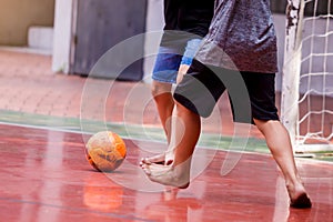 Futsal players barefoot. Futsal player  control and shoot ball to goal. Soccer players fighting each other by kicking the ball