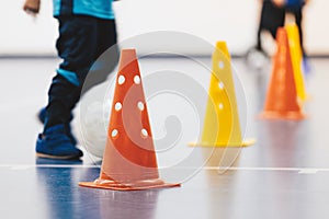 Futsal training drill for school children. Little boy kicking indoor soccer ball