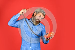 Future of advertising. senior man hipster showing old telephone. brutal guy with telephone. mature bearded man talk on