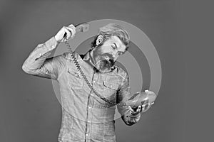 future of advertising. senior man hipster showing old telephone. brutal guy with telephone. mature bearded man talk on