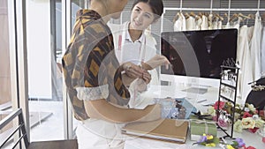 Future bride customer talking with wedding store shopkeeper