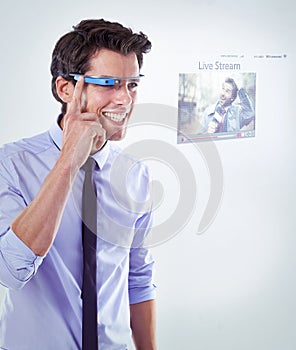 The future of business is here. Studio shot of a young businessman against a white background wearing smart glasses.