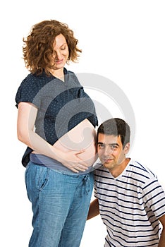 Future father listening to his wife tummy