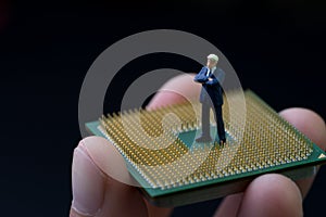 Future of human, smart artificial intelligent, AI concept, miniature figure businessman standing on computer chip in real human h