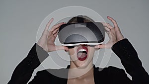 Future is now. Beautiful woman touch something using modern virtual reality glasses. Attractive woman wearing virtual