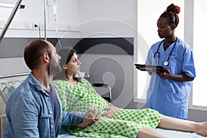 Future parents discussing with nurse