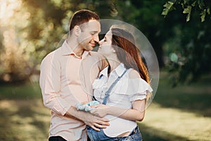 Future parents with knitted shoes for unborn baby