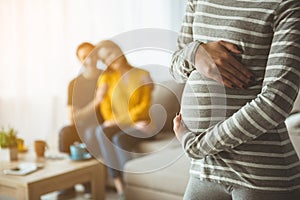 Future parents looking at surrogate expectant mother photo