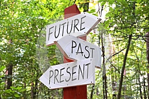 Future, past, present - signpost with three arrows