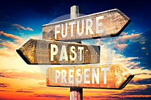 Future, past, present - wooden signpost, roadsign with three arrows