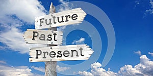 Future, past, present - wooden signpost with three arrows