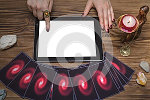 Future reading online template. Tarot cards and tablet computer with blank screen.