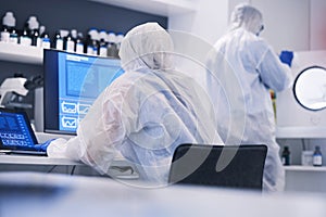 Future, research and science team in an investigation of hazard, virus and in a chemistry laboratory with computer. DNA