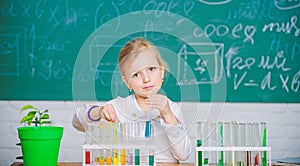 Future scientist. Explore and investigate. School lesson. Girl cute school pupil play with test tubes and colorful