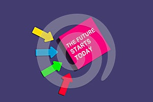 The future starts today - concept of text on sticky note. Pink square sticky note and colorful arrows on purple background, top