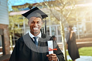 The future sure looks bright from here. Portrait of a happy young man holding a diploma on graduation day.