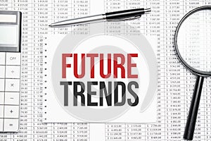 Future trends text on paper with calculator,magnifier ,pen on the graph background