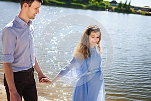 Future mother and father walking near lake