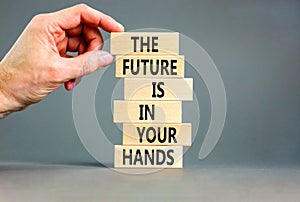 The future is in your hands symbol. Concept words The future is in your hands on wooden blocks on a beautiful grey table grey