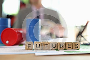 Futures collected with wooden cubes and oil barrels on financial documents