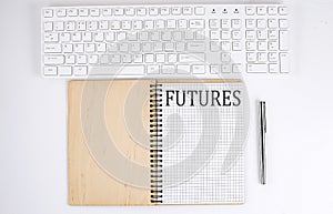 FUTURES text on the notebook with keyboard on the white background