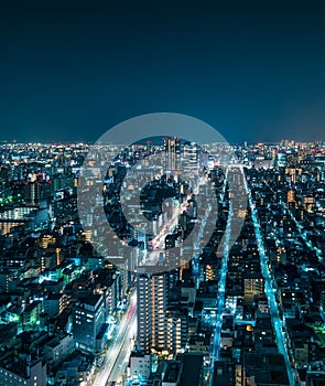 Futuristic Aerial View of City Rooftops at Night in Tokyo, Japan