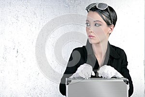 Futuristic businesswoman holding silver briefcase