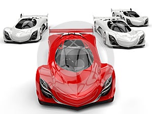 Futuristic concept race sports cars racing - red in front of all the white ones