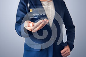 Futuristic Credit Card Banking and Business Financial Concept, Business Woman Holding Electronic Hologram Credit Card for Customer