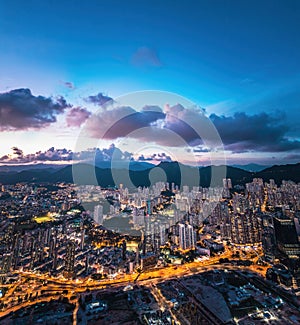 Futuristic cyberpunk view of the famous metropolis, night aerial view of Kowloong Hong Kong