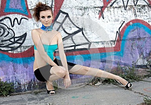 Futuristic fashion model near graffiti wall