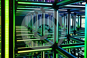 Futuristic green neon light cube art installation. Technology cyber cube
