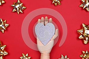 Futuristic image with a robot hand holding silver sparkling heart. Robotic, ai, science, connection, technology