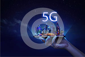 Futuristic infrastructure of a smart night city. Residential urban buildings. 5G City infrastructure, data traffic, ensure safety