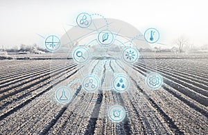 Futuristic innovative technology pictogram on a winter farm field. Agricultural startups, improvements, digitalization