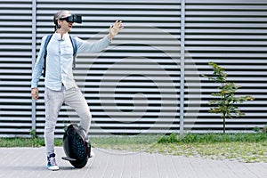 Futuristic man male with virtual reality glasses and electric transport