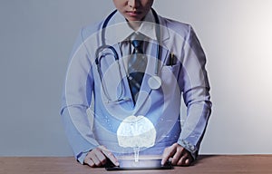 Futuristic medical and technology concept, woman doctor with smart device and brain model for anatomy of brain