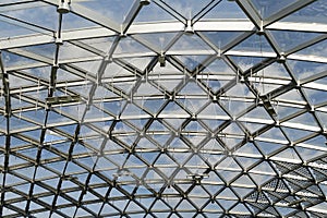 Futuristic metal and glass roof design. Modern ceiling with elements of glass, metal mesh