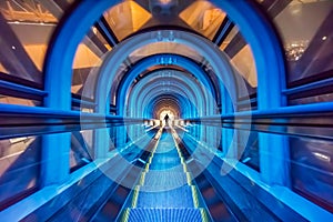 Modern tunnel escalator with traveler at Umeda Sky Building