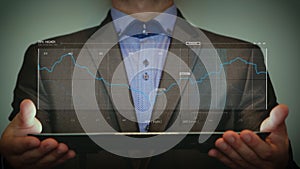 Futuristic portrait of a businessman uses a career chart, a hologram, a diagram, in a suit, makes a finger click. Concept: future,