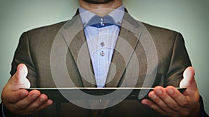 Futuristic portrait of a businessman uses a career chart, a hologram, a diagram, in a suit, makes a finger click. Concept: future,