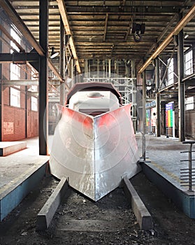 Futuristic red train inside an ancient coal mine