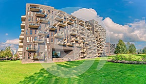 Futuristic residential house with rectangular balconies near a green Byparken park in Ã˜restad city area. Copenhagen,