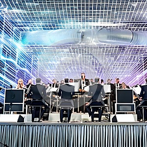 A futuristic robot orchestra performing a symphony of electronic music in a grand concert hall3, Generative AI